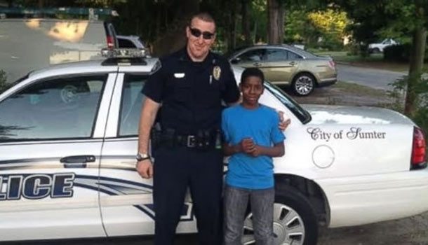 Officer Gaetano Acerra standing next to 13-year-old Cameron Simmons