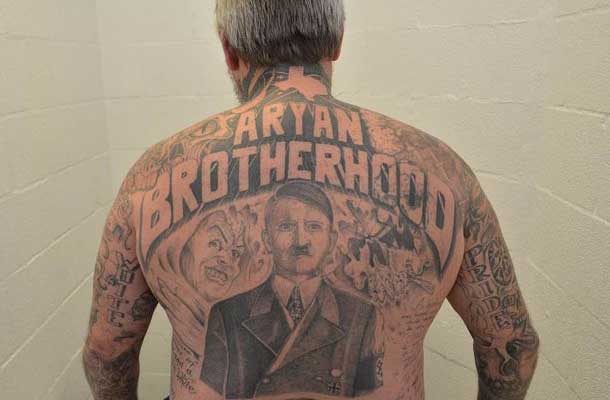 Close up of back tattoo featuring hitler