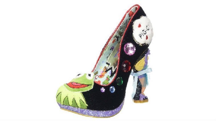 A high heeled shoe with a frog figure