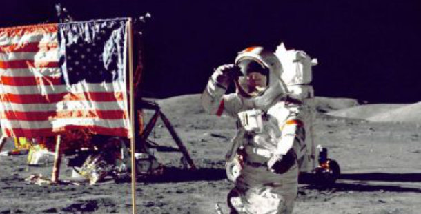 An astronaut saluting on the moon next to the American flag.