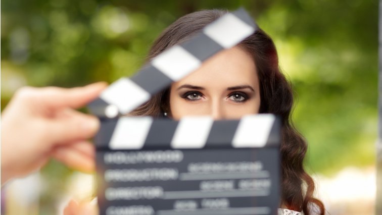 A person holding a movie clapper