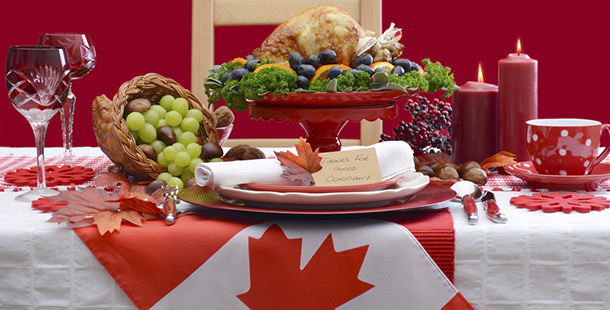 A thanksgiving meal on a table with a canadian flag