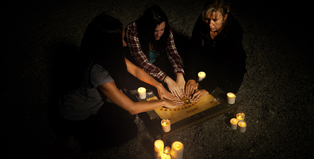 Three women using a ouija board