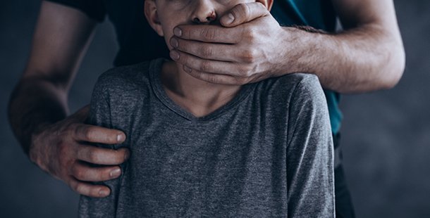 A person covering their mouth with their hands