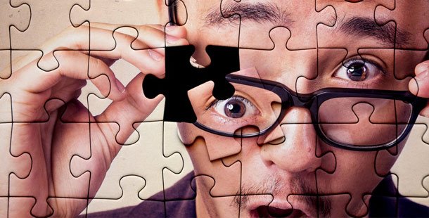 A person with glasses and a puzzle piece