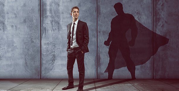 A person in a suit and tie with superhero shadow