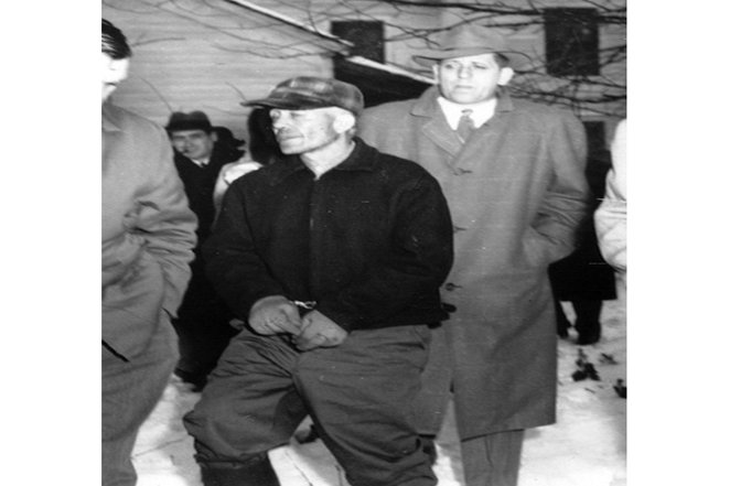 CWAEA6 Serial Killer Ed Gein is led away from his farm by detectives, Plainfield, Wisconsin, November 18, 1957. Courtesy: CSU Archives