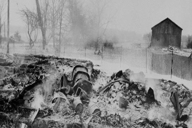 20 Mar 1958, Plainfield, Wisconsin, USA --- Smoldering ruins is all that remains of the House of Horrors after a fire of undetermined cause destroyed the two story frame building on March 20, 1958. Once the home of confessed killer ghoul Ed Gein, who shocked the nation when human remains were found in it, the house was to be auctioned. Police suspected arson. --- Image by © Bettmann/CORBIS