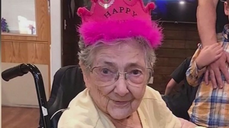 An old person wearing a pink crown