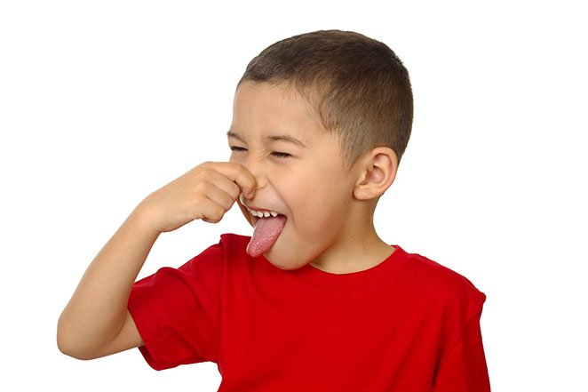 kid holding his nose, isolated on white
