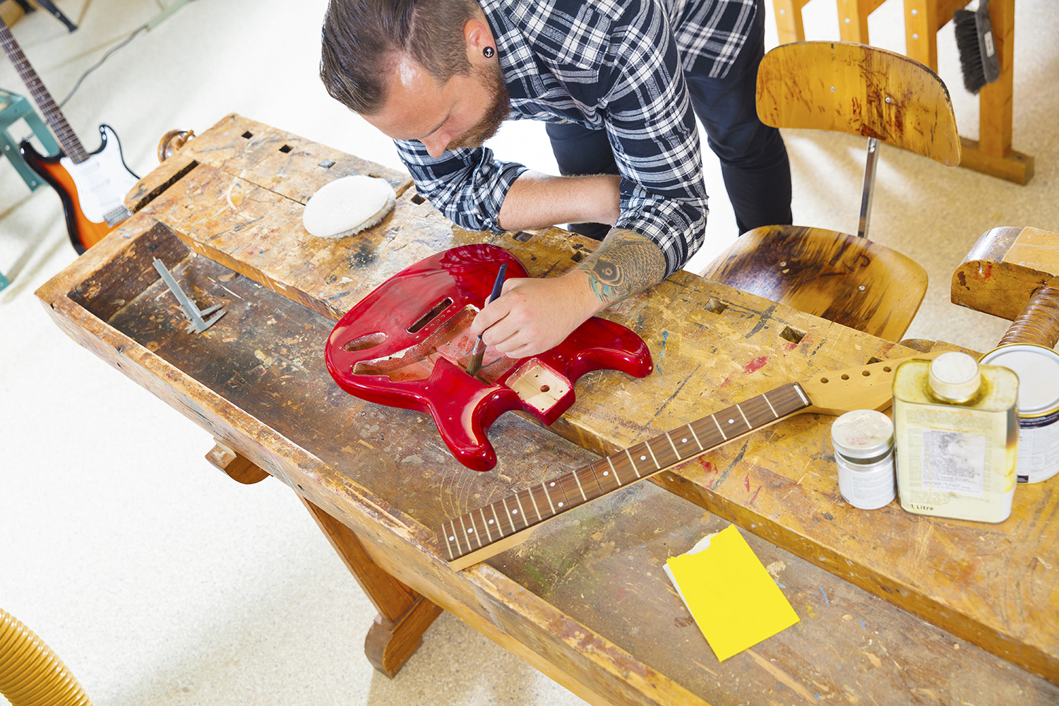 A person working on a guitar
