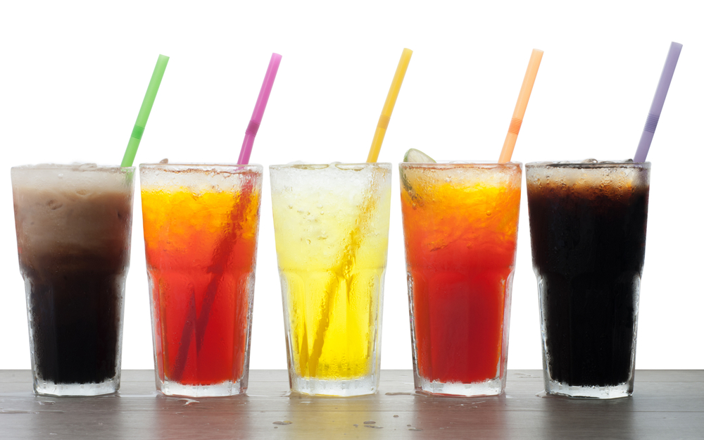 A group of drinks with straws