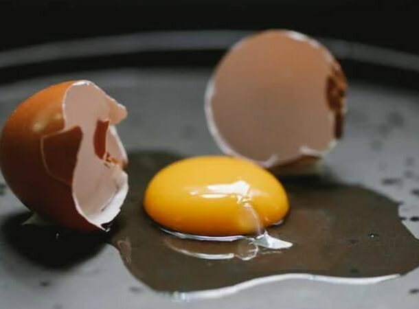Broken chicken egg placed on black plate