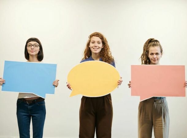 Women Holding Bubble Text Cards