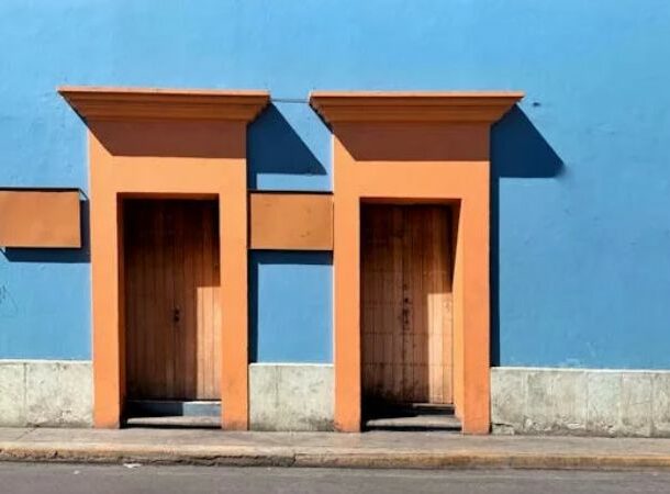 Doors in Blue Building Wall